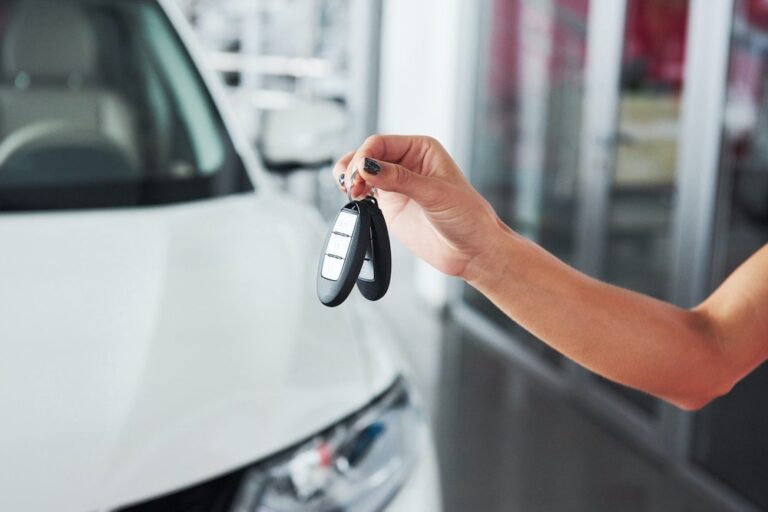 The Hidden Profits of Dealer Reinsurance 4 Person holding car keys to depict selling auto dealer reinsurance.